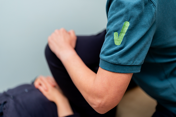 Physiotherapist testing flexibility