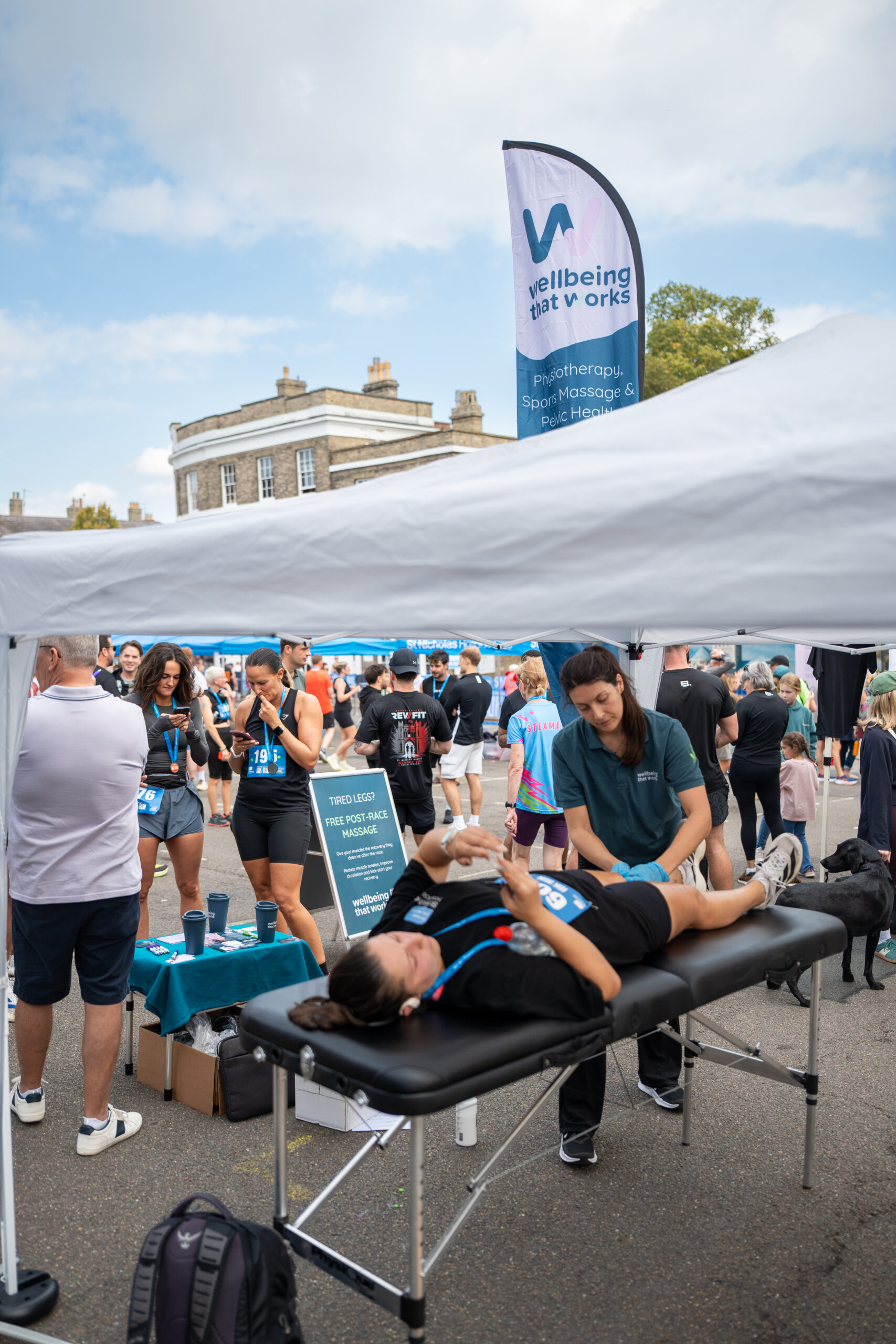 St Nicholas’ 10K Bury St Edmunds: Supporting Local Runners and Community Wellbeing Event massage treatment taking place under a gazebo at the St Nicholas' 10K.