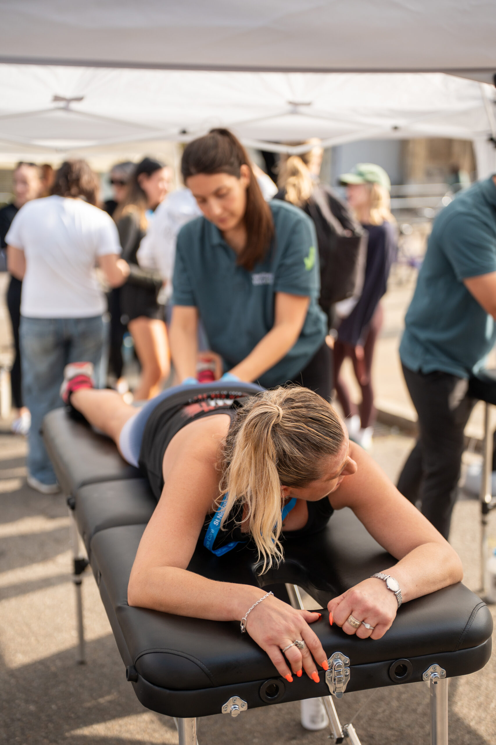St Nicholas’ 10K Bury St Edmunds: Supporting Local Runners and Community Wellbeing Sports massage being provided to a runner after the St Nicholas' 10K.