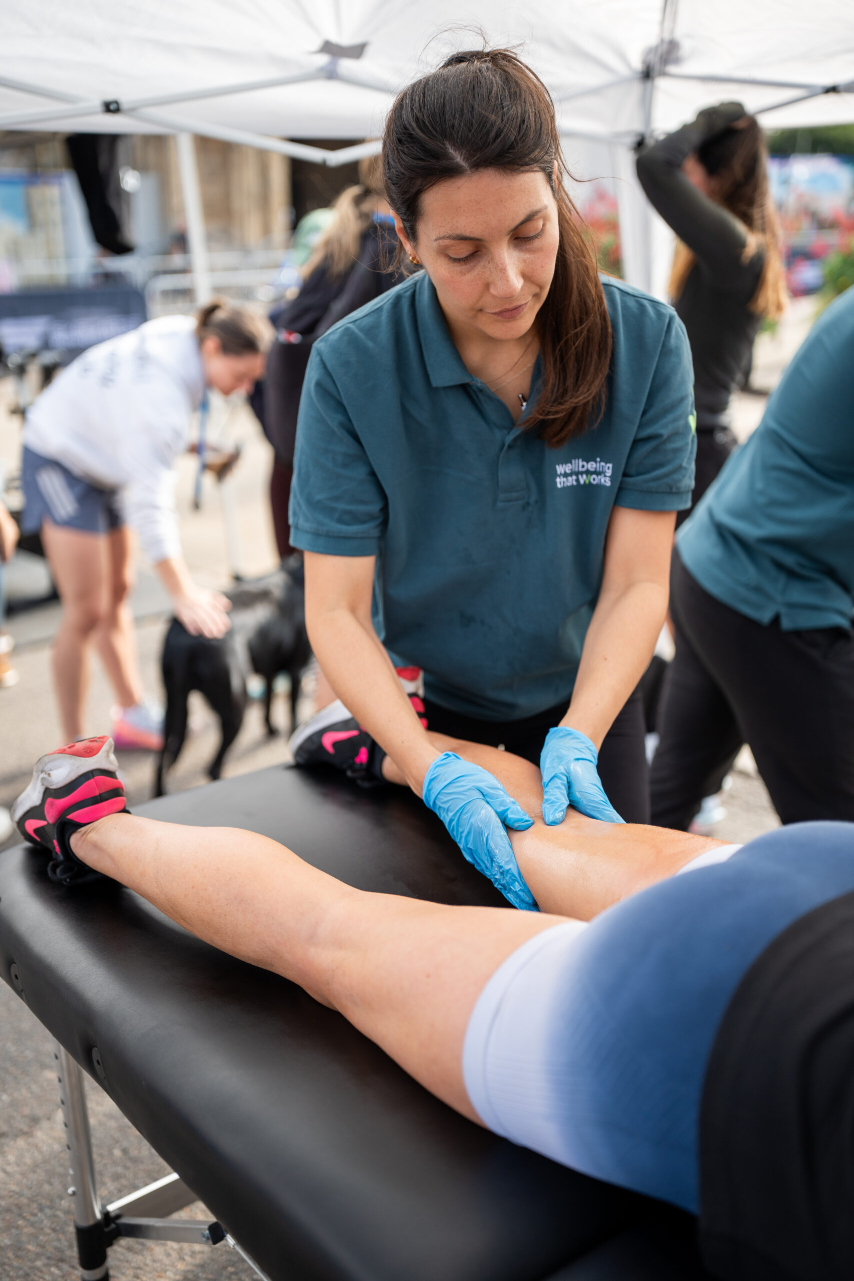 St Nicholas’ 10K Bury St Edmunds: Supporting Local Runners and Community Wellbeing Lower leg sports massage being provided to a runner after the race.