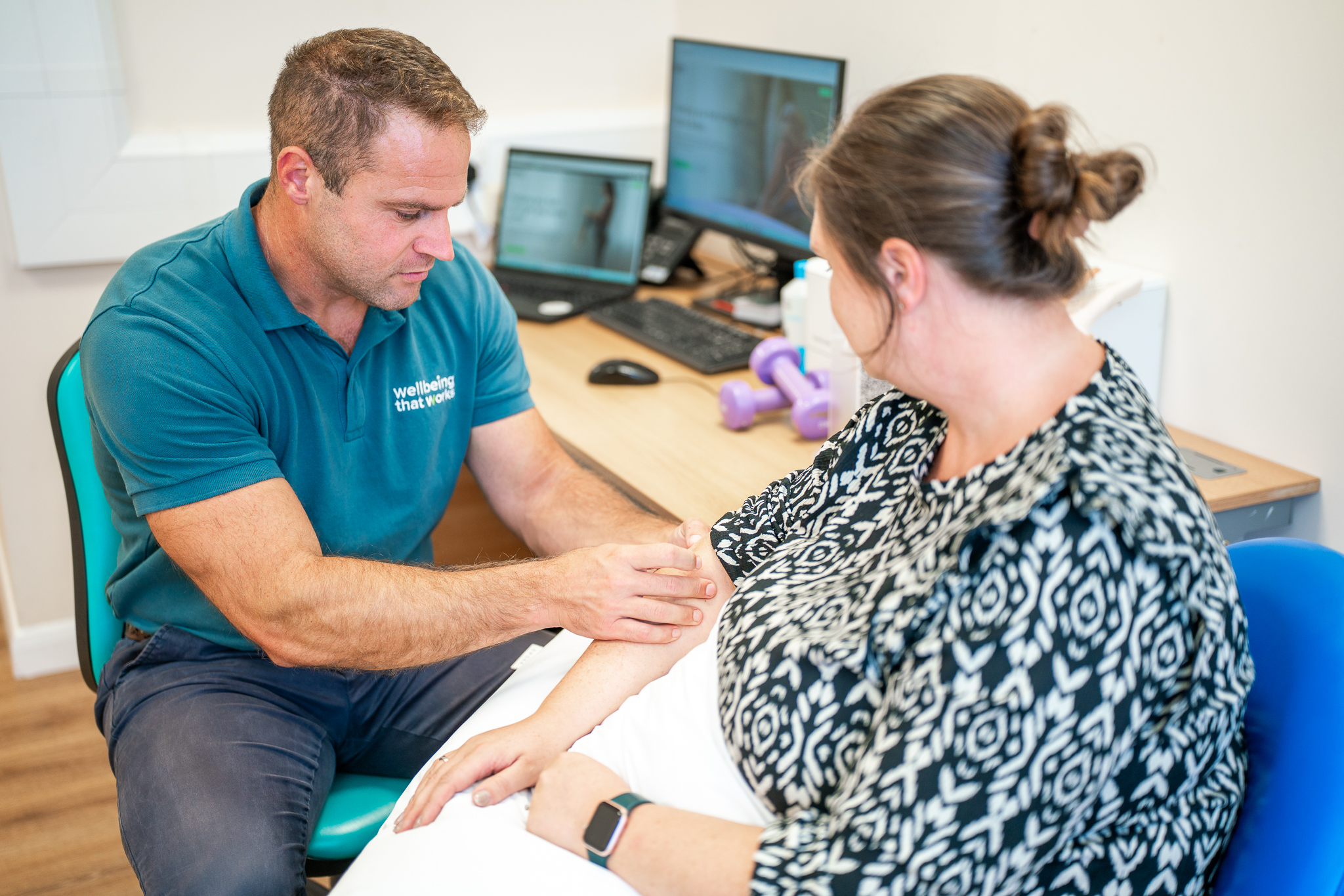 Physiotherapy Assessment Physiotherapist assessing wrist and arm function during a clinical appointment.