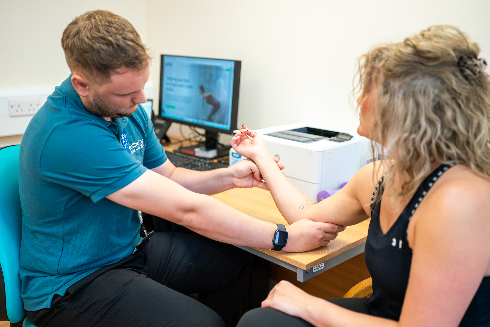 Arm Assessment Physiotherapy Physiotherapist assessing arm and shoulder movement during a clinical examination.